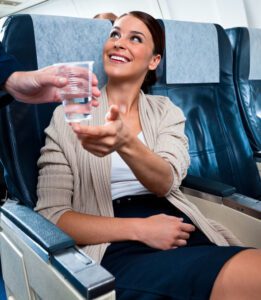 Drink water instead of alcohol or soda during your flight