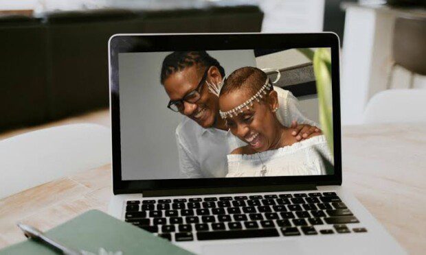 How to host the perfect Zoom wedding - couple displayed on a laptop