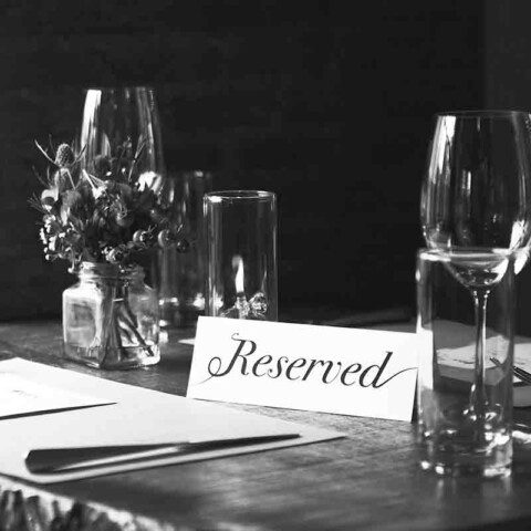 places where you can meet rich people - image of reserved table